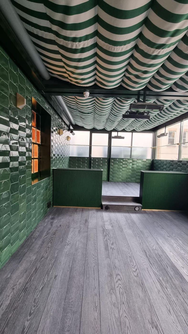 Commercial interior fit-out with green tiling and timber flooring
