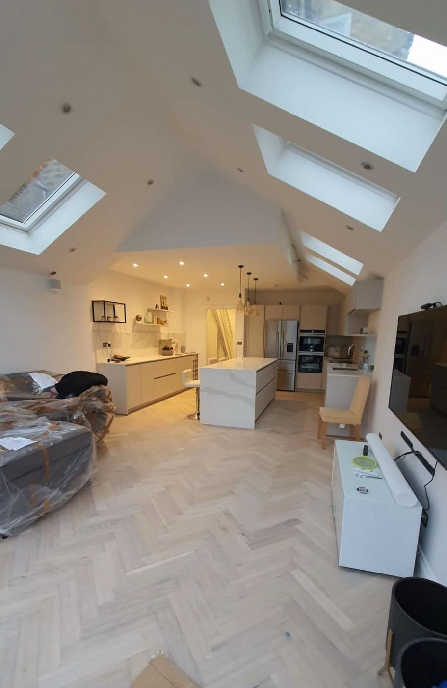 Herringbone floor kitchen under vaulted rooflights