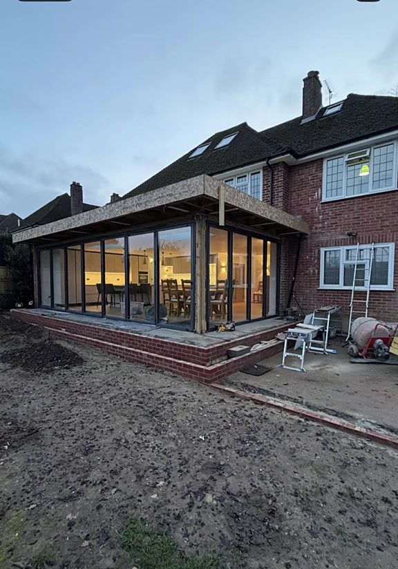 Finished glazed extension lit up at dusk